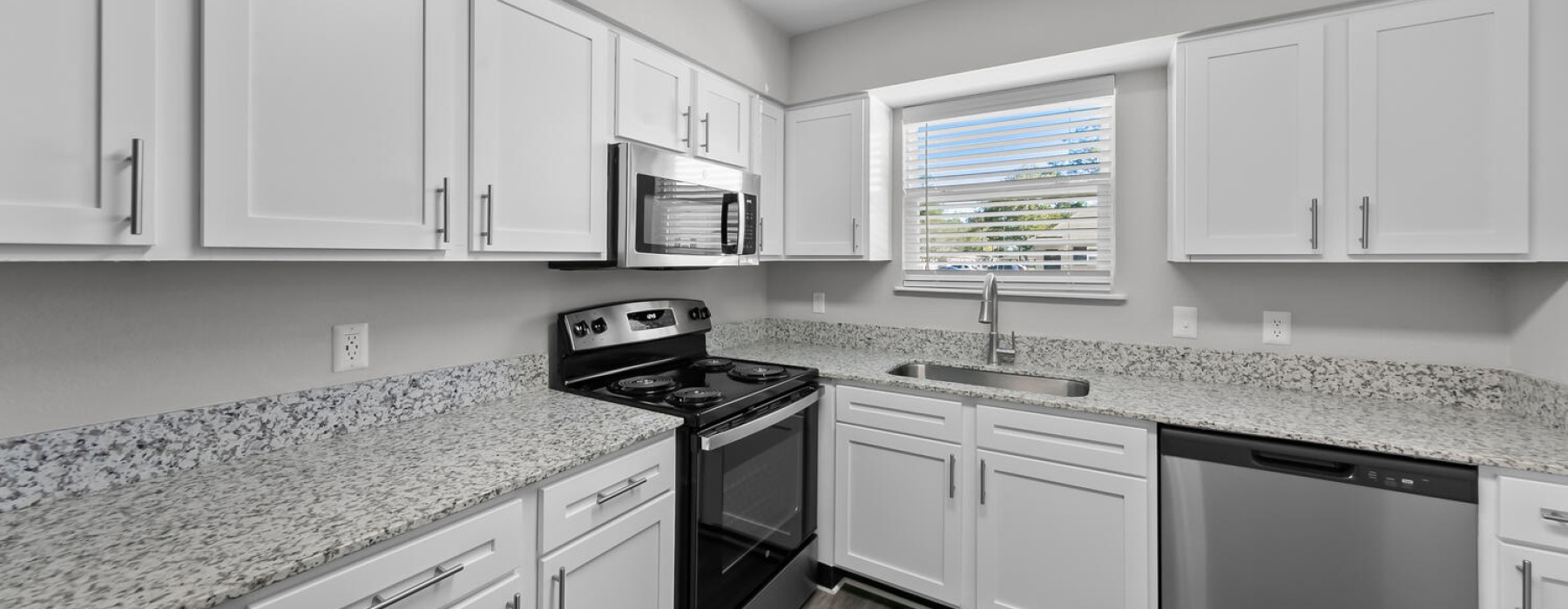 Kitchen with white cabinets and stainless steel appliances