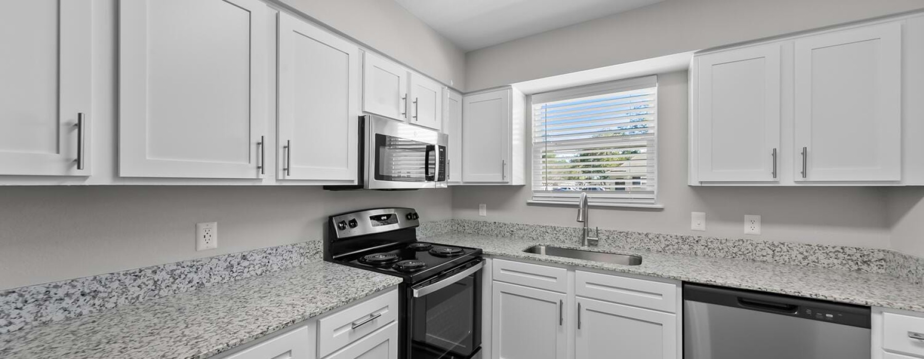 Kitchen with white cabinets and stainless steel appliances