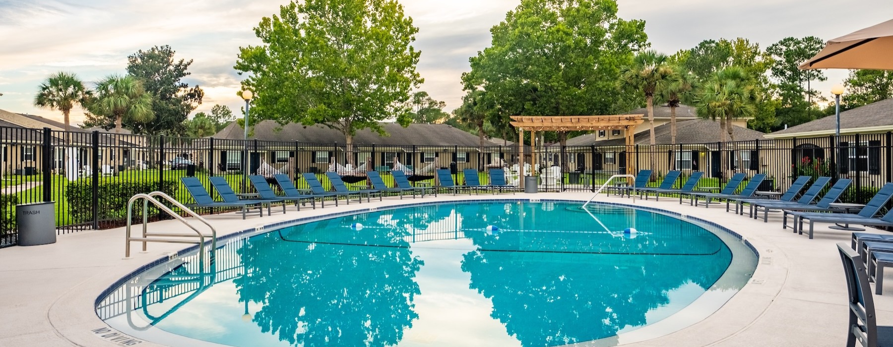 a swimming pool with chairs around it