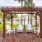 a gazebo with chairs and a table in front of it