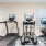 a room with exercise equipment and a tv