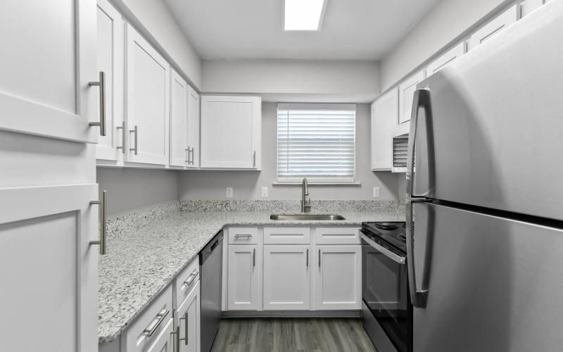 a kitchen with white cabinets