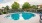 a swimming pool with chairs around it