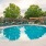 a swimming pool with chairs around it