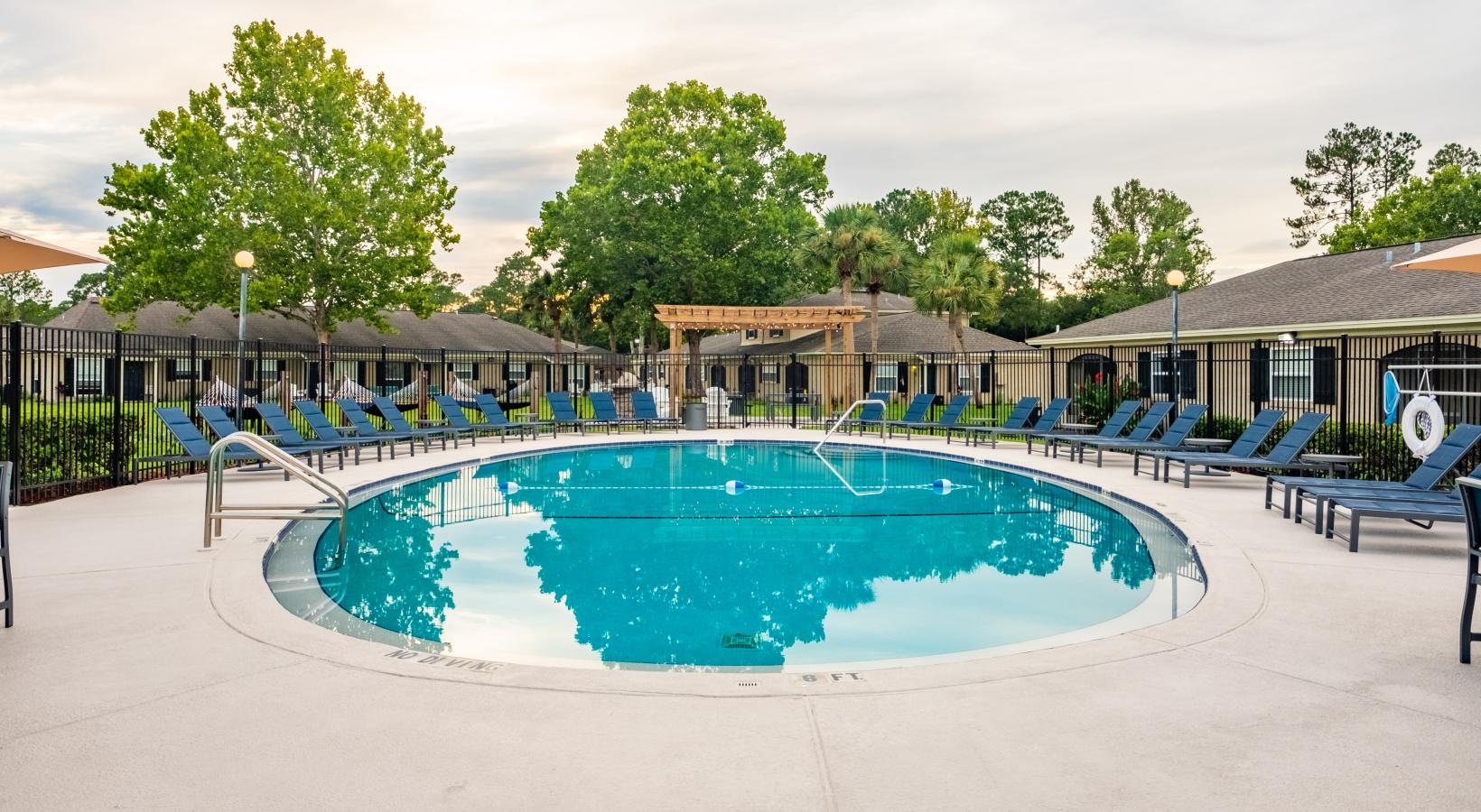 Relax and unwind poolside a swimming pool in a backyard