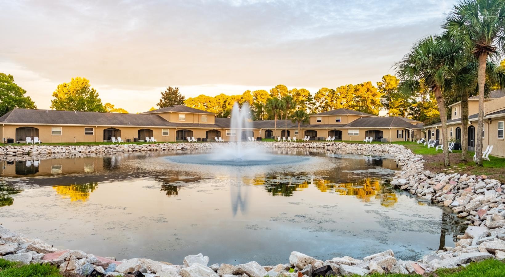 Settle into comfort at Pickwick Flats a fountain in a pond